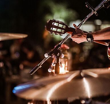 The musicians were playing rock music on stage, there was an aud